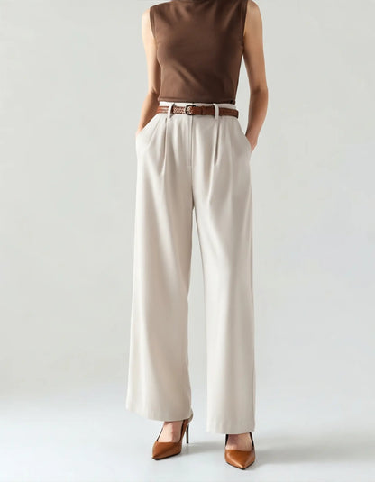 
Women's off-white high-waist pleated wide-leg trousers styled with brown heels and a woven belt, fluid lightweight fabric
