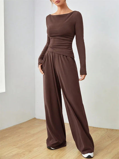 Two-piece co-ord with long-sleeve boat-neck jersey top and wide-leg trousers on model Vohran UK