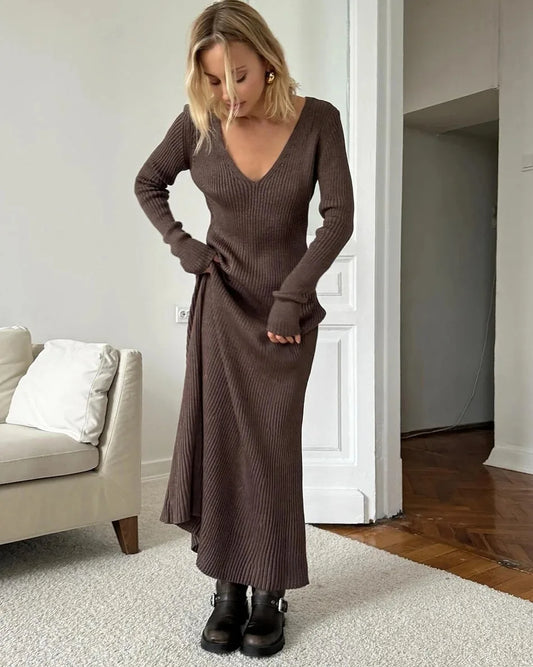Woman wearing Vohran knitted V-neck A-line midi dress with long sleeves, elegant and structured silhouette Vohran UK.