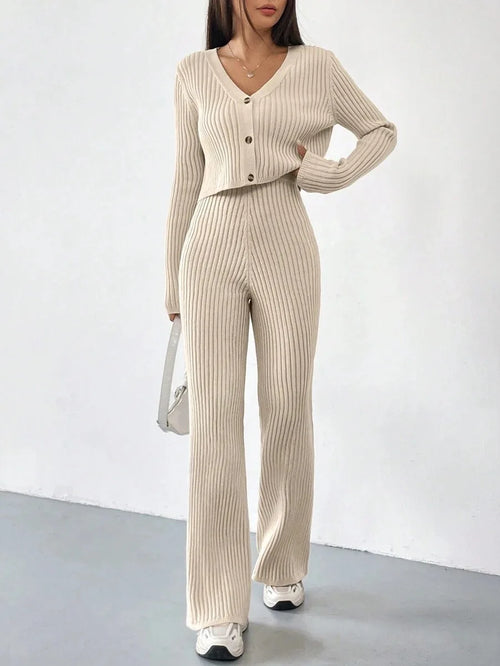 Ribbed knit co-ord with V-neck button cardigan and flared trousers on model Vohran UK