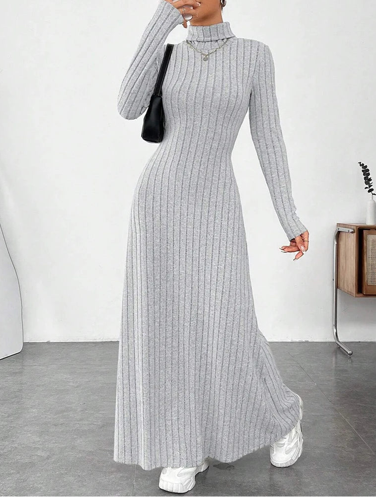 Woman wearing Vohran ribbed high-neck knit maxi dress with long sleeves and high neckline Vohran UK.