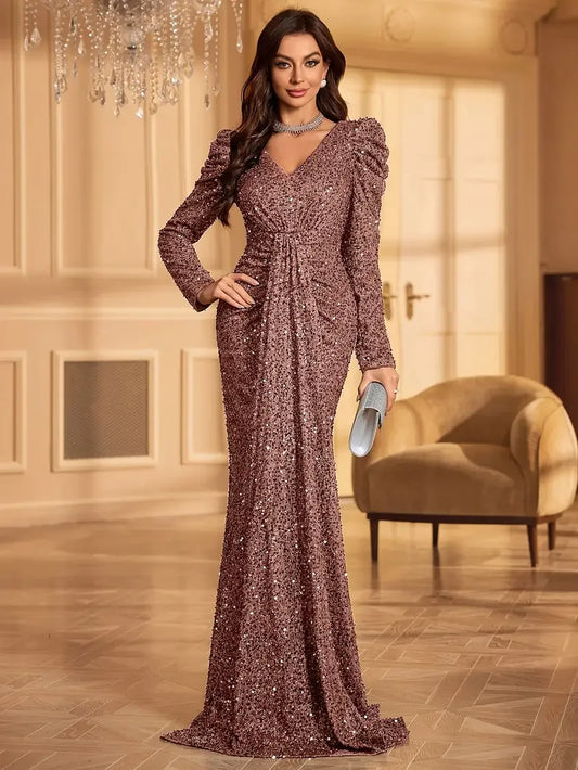 Woman wearing a rosé sequin full-length evening gown with structured shoulders and gathered waist in an elegant indoor setting Vohran UK.